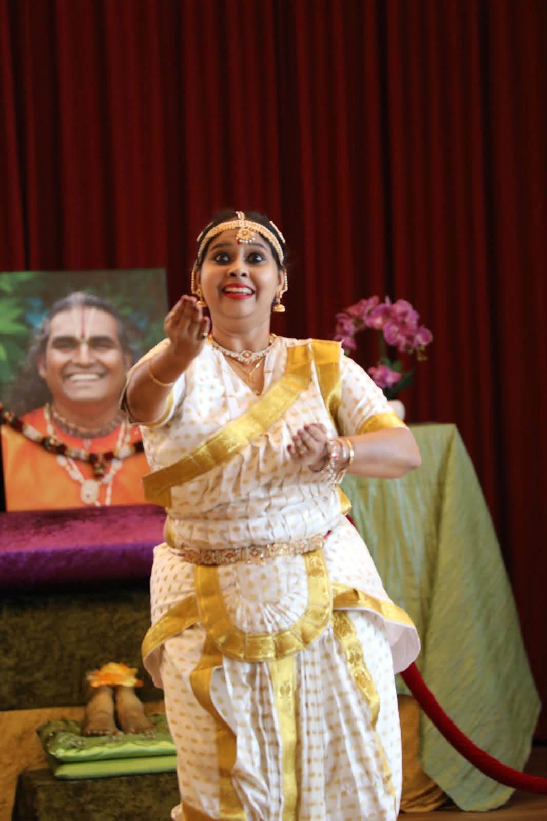 Classical dance pose, white and gold costume, second angle