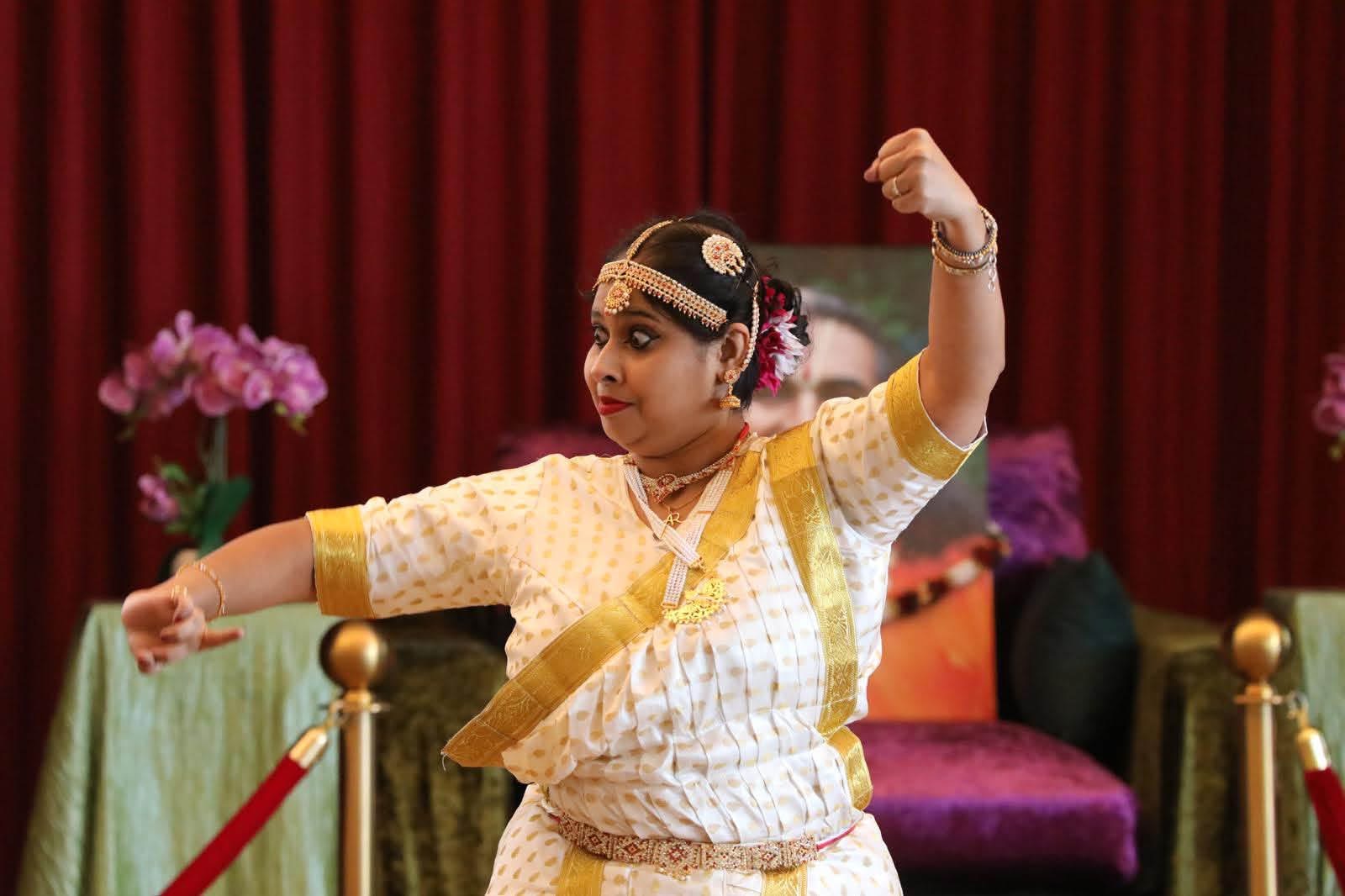 Classical dance pose, white and gold costume, third angle