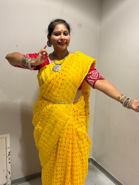 Portrait at a cultural exhibition in a cream saree